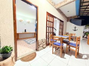 a dining room with a table and chairs on a patio at Pousada Azul do Mar by BlueOcean in Arraial do Cabo
