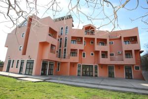 an orange building with a lot of windows at Guesthouse Orlović in Budva