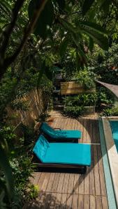 two blue chairs sitting on a deck next to a pool at casa kashiikaii in Palomino