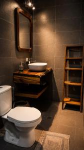 a bathroom with a white toilet and a sink at casa kashiikaii in Palomino +52 photos