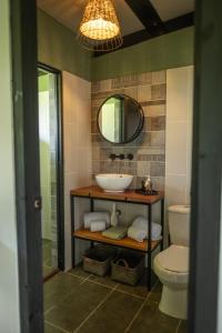 a bathroom with a sink and a toilet at Somni Hill in Torio