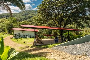 a picnic shelter with a red roof at Somni Hill in Torio
