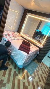a man is making a bed in a room at Gold House Premium in Hacienda Mera +2 photos