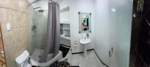 a bathroom with a shower and a toilet and a sink at Gold House Premium in Hacienda Mera