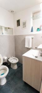 a bathroom with a toilet and a sink at Ushuaia Magnifica,cabaña con balcon,luminosa y calida in Ushuaia +8 photos