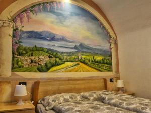 a bedroom with a large painting on the wall at B&B Antiche Mura in Puegnano del Garda