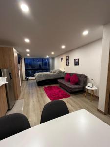 a living room with a couch and a table at HOSTARA EDIFICIO CAPITALIA, El Cable, Manizales in Manizales