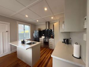 a kitchen with a sink and a counter top at Maison Millie - Central Pet-Friendly Sleeps 4 in Rotorua