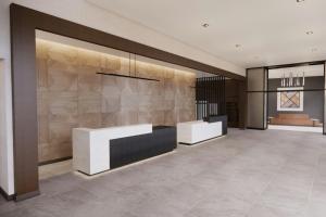 a lobby with two reception desks in a building at AC Hotel Lenexa City Center in Lenexa