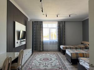 a hotel room with two beds and a window at Saty Guest House in Saty