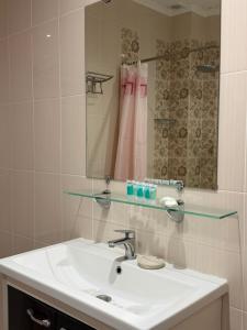 a bathroom with a sink and a mirror at Saty Guest House in Saty +19 photos