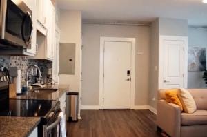 a kitchen with a couch and a white door at Cantlley Noewsy in Wilmington +2 photos