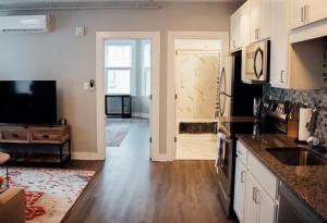a kitchen with a sink and a door to a room at Cantlley Noewsy in Wilmington