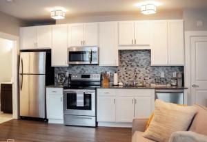 a kitchen with white cabinets and stainless steel appliances at Cantlley Noewsy in Wilmington