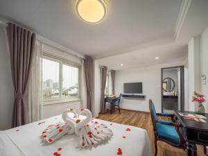 a hotel room with a bed with a bow on it at Ritana Boutique Hotel & Spa in Hanoi +120 photos