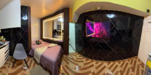 a room with a bed and a tv on a wall at Gold House Premium in Quito +2 photos