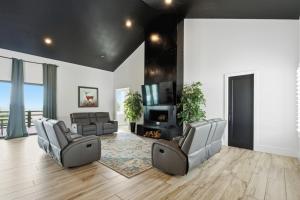 a living room with two chairs and a fireplace at Sunset Acres Ideal for all Occasions in Clermont