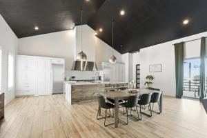 a kitchen and dining room with a table and chairs at Sunset Acres Ideal for all Occasions in Clermont