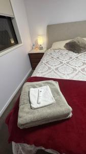 a hotel room with a towel on the bed at Cozy Quiet Beach room R2 in Brighton