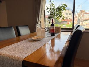 a wooden table with a bottle of wine and a glass at OZ Fuji in Fujiyoshida