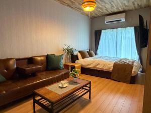 a living room with a couch and a bed at OZ Fuji in Fujiyoshida