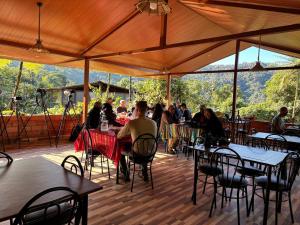 a group of people sitting at tables under a tent at Mashpi Amagusa Lodge in Mashpi