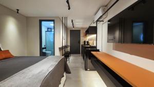a bedroom with a bed and a desk in it at Flat Praiano Intermares Boutique in Cabedelo