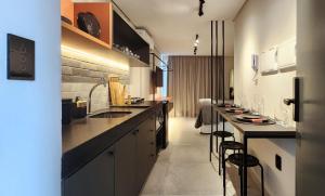 a kitchen with a long counter and some bar stools at Flat Praiano Intermares Boutique in Cabedelo