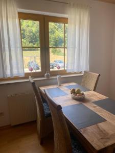 a dining room table with a bowl of fruit on it at Ferienwohnung am Möhntal in Heidenheim an der Brenz
