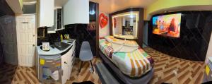 a small bedroom with a bed and a sink at Gold House Premium in Quito