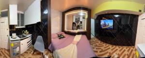 a bathroom with a bed and a sink and a mirror at Gold House Premium in Quito