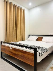 a bedroom with a bed with a zebra print mattress at Lohith International in Shimoga