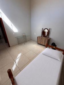 a white bedroom with a bed and a table at Galante in Toledo
