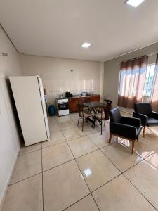 a kitchen with a table and chairs and a refrigerator at Galante in Toledo +1 photo