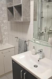 a bathroom with a sink and a mirror at Guest house Gloria in Šilo +13 photos