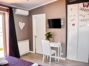 a room with a desk and a tv on a wall at Villa Erasi in Fiumicino