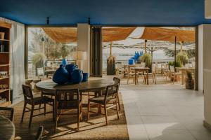 a dining room with a table and chairs at Sabatic Formentera Autograph Collection in Es Pujols