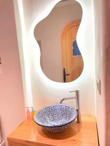 a bathroom with a sink and a mirror at Riad Nassar in Chefchaouen +32 photos