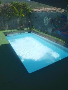a swimming pool with blue water in a backyard at Hotel Boutique Urban in San Gil