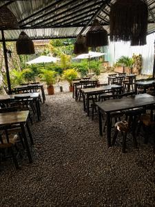 an empty restaurant with tables and chairs and umbrellas at Hotel Boutique Urban in San Gil