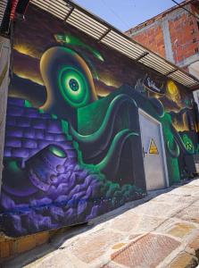 a wall with a painting of aopus on it at Hotel Boutique Urban in San Gil