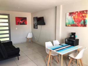 a living room with a table and chairs at Beautiful Apartment Executive 3 in Guadalupe
