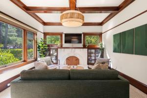 a living room with a couch and a fireplace at Design-Forward | Steps to Shops & Dining | 2 Kings in Mill Valley