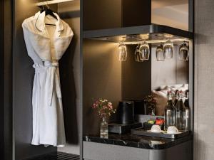 a robe hanging on a rack in a hotel room at M'Gloria Cruise by HAG in Ha Long +41 photos