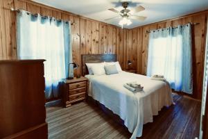 a bedroom with a bed and a ceiling fan at Turn On Inn in Lake Village