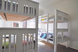 two bunk beds in a room with a bed at Plovers Rest in Inverloch