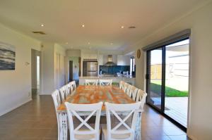 a kitchen and dining room with a table and chairs at Plovers Rest in Inverloch