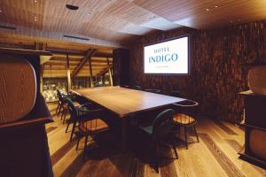 a dining room with a wooden table and chairs at Hotel Indigo Karuizawa by IHG in Karuizawa +174 photos
