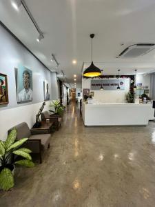 a lobby with a waiting room with couches and a counter at Mamma Rose Hotel in Legazpi