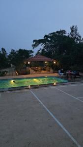 a parking lot with a pavilion in the background at Peony By Dhiya in Jadgenhalli